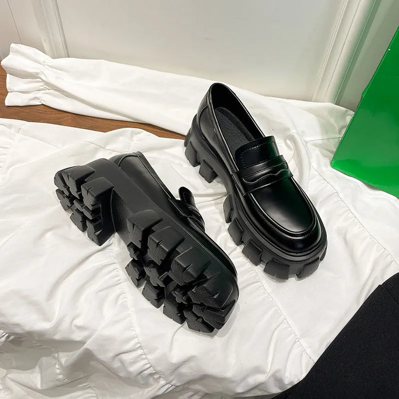 Men's wide fit British style loafers in patent leather with a rubber sole and muffin heel.
