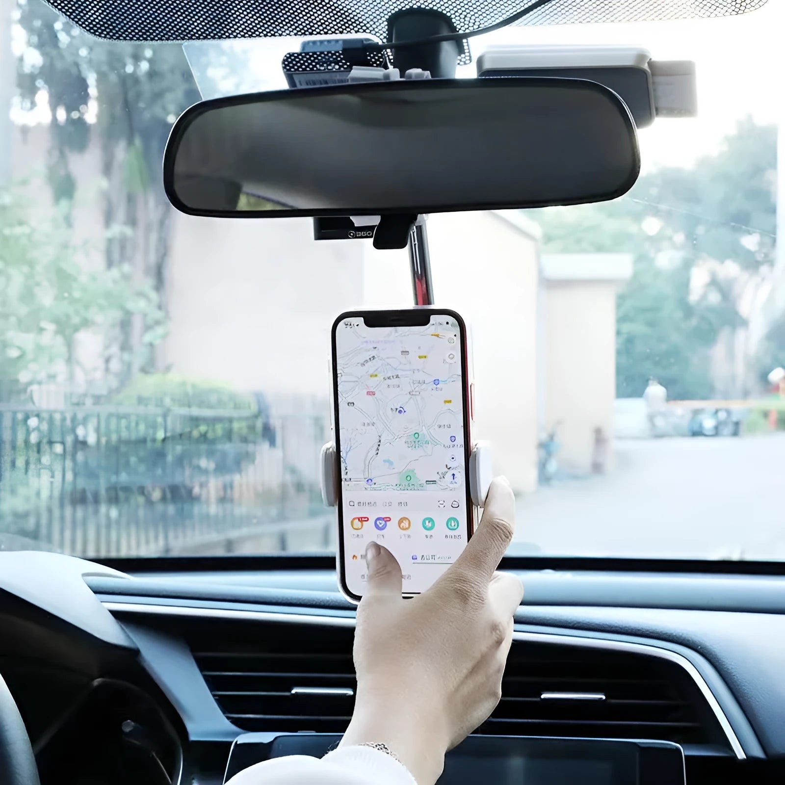 Black ABS mobile phone bracket attached to car rearview mirror holding smartphone
