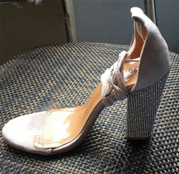 Women's black and gold pointed toe plastic high heel shoes on size label.