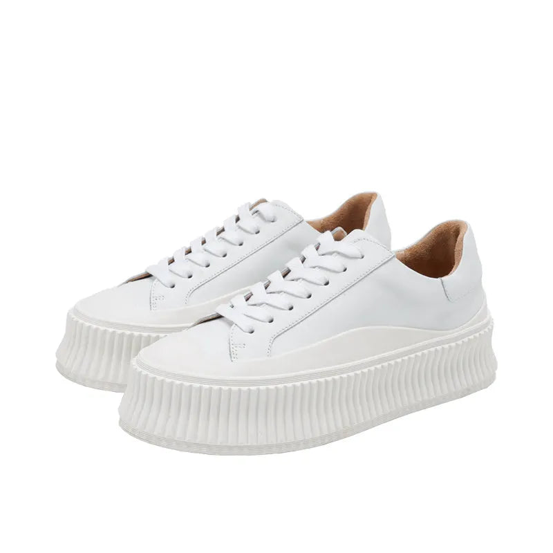 Women's black and white suede platform sneakers with back lacing and a thick sole for height increase.