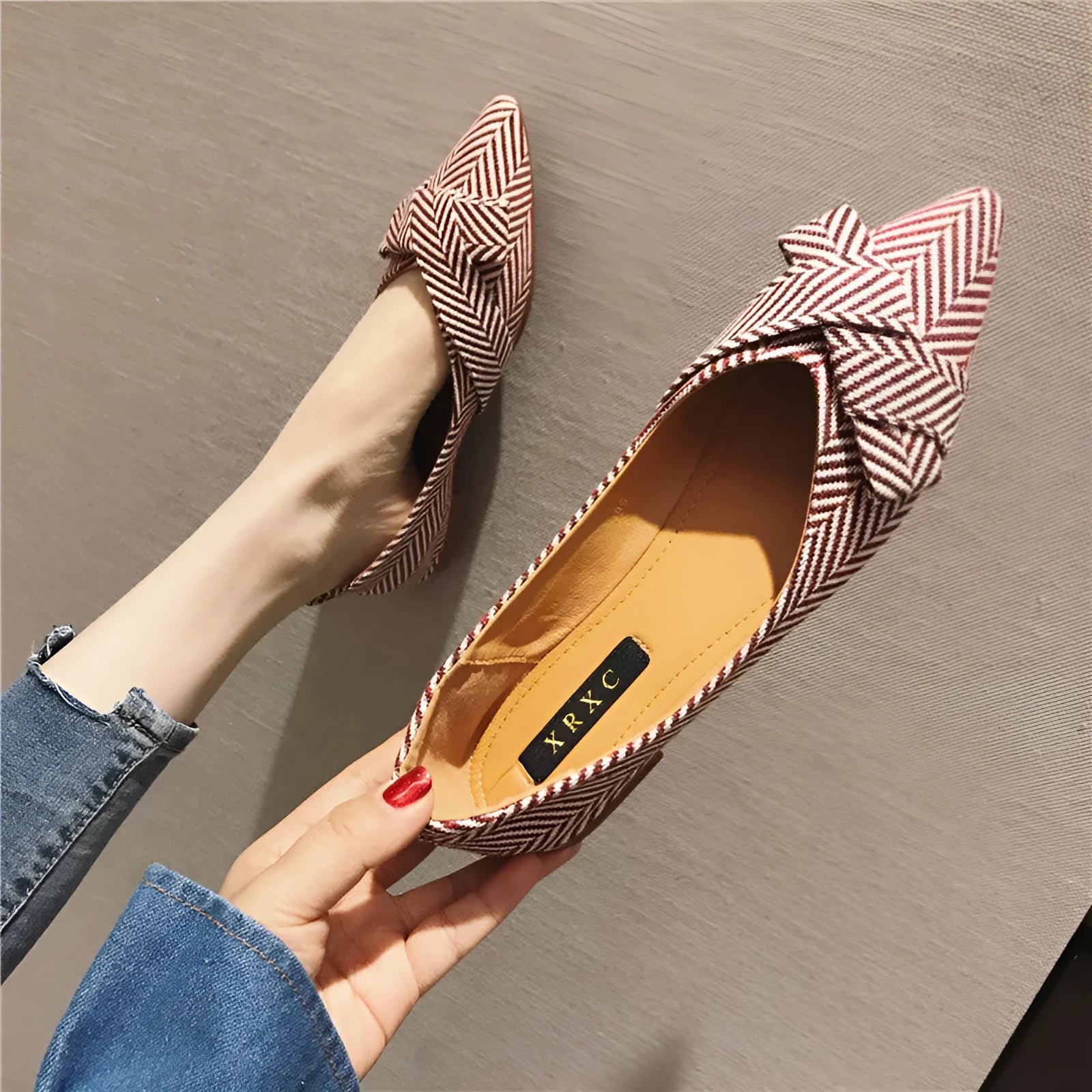 Women's red and black pointed-toe flat shoes with a low heel and cotton upper.