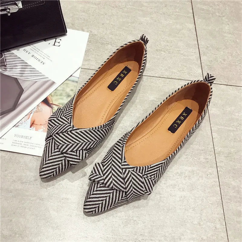 Women's red and black pointed-toe flat shoes with a low heel and cotton upper.