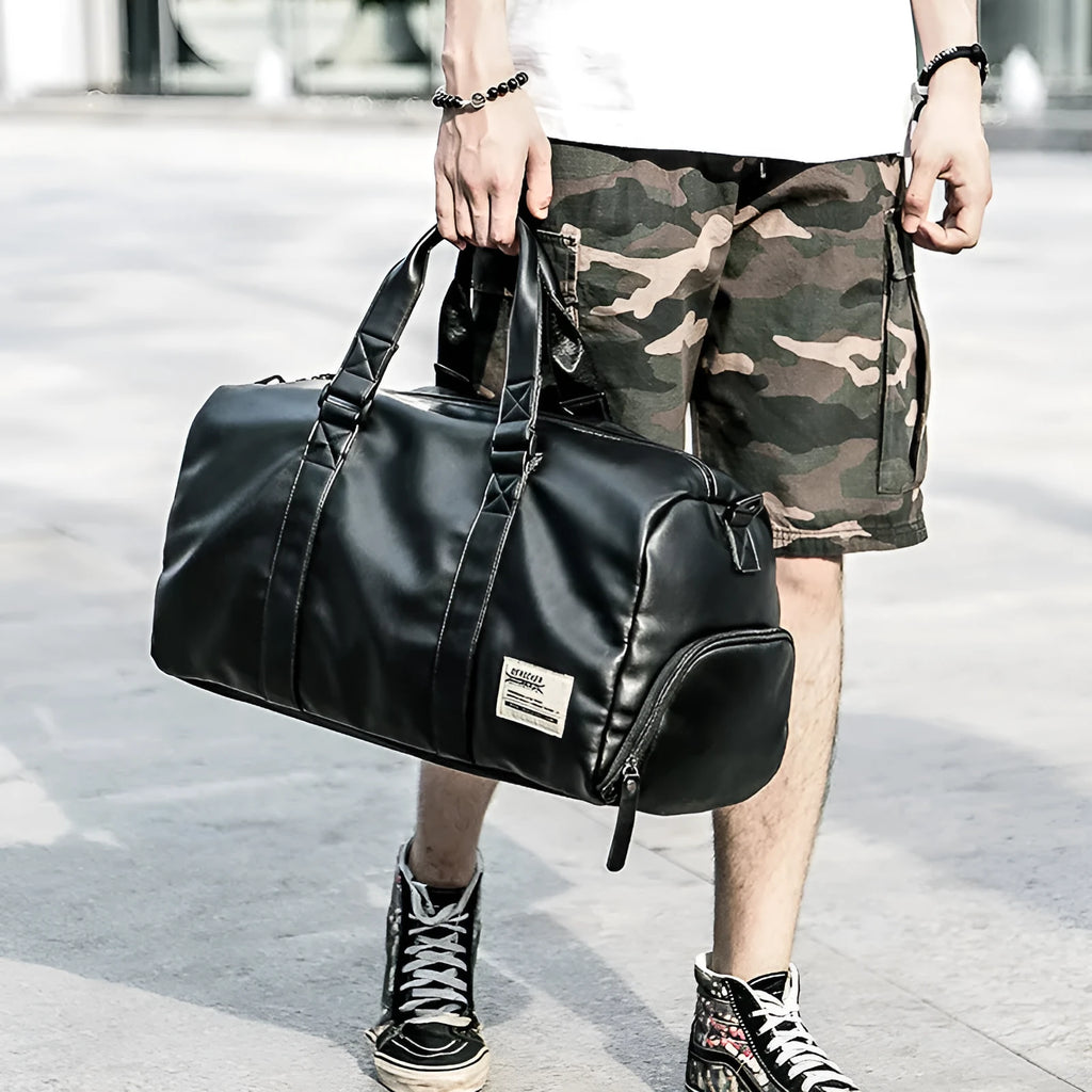 Large black waterproof PU leather sports training bag with multiple internal pockets and single strap