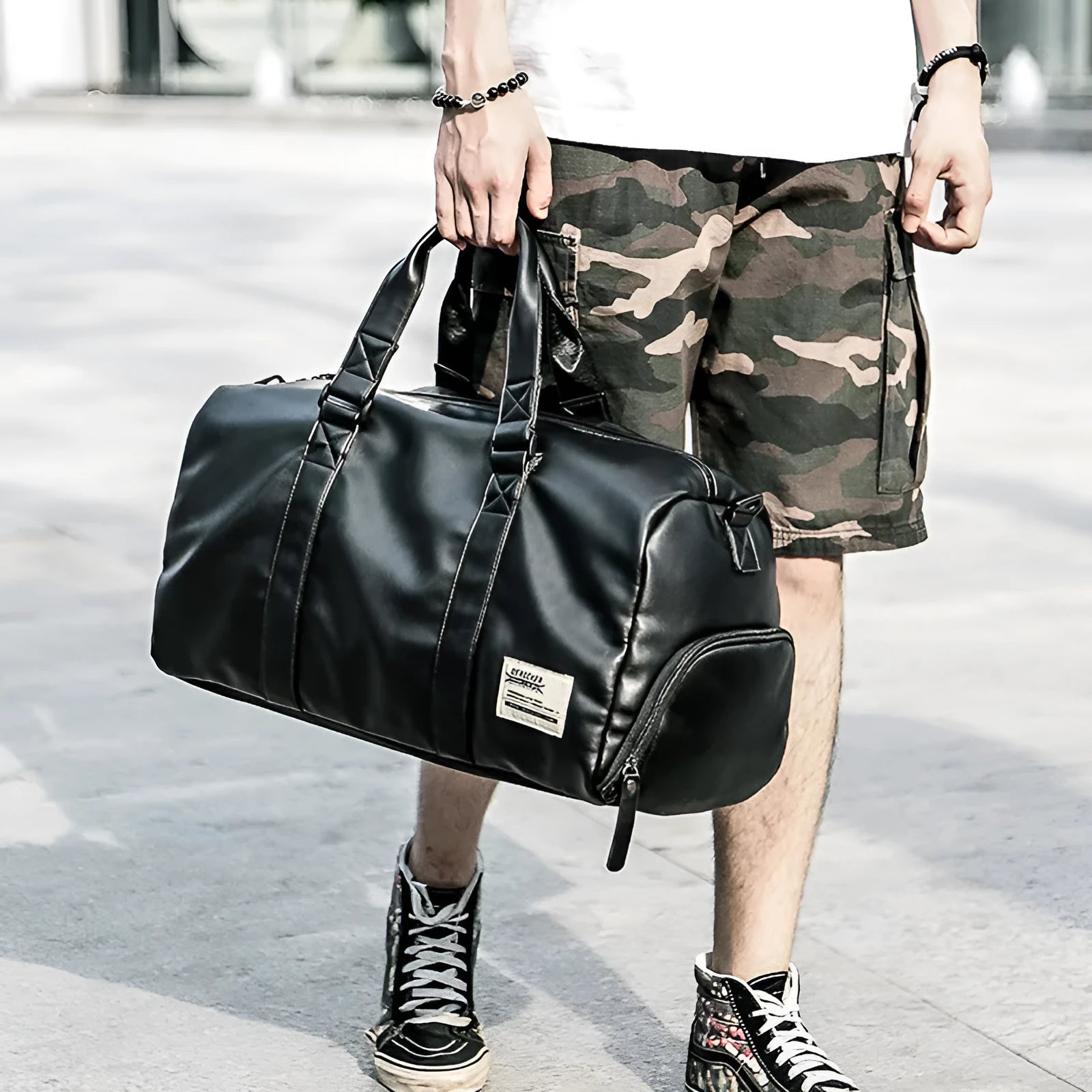 Large black waterproof PU leather sports training bag with multiple internal pockets and single strap