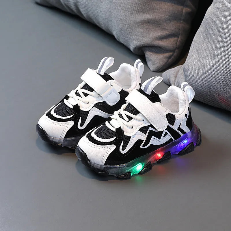 Children's black breathable mesh and PU Velcro sneakers with a rubber sole on a white background.