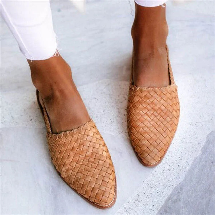 Pointed toe flat sandals with a buckle fastener on the upper, shown in a selection of colours.