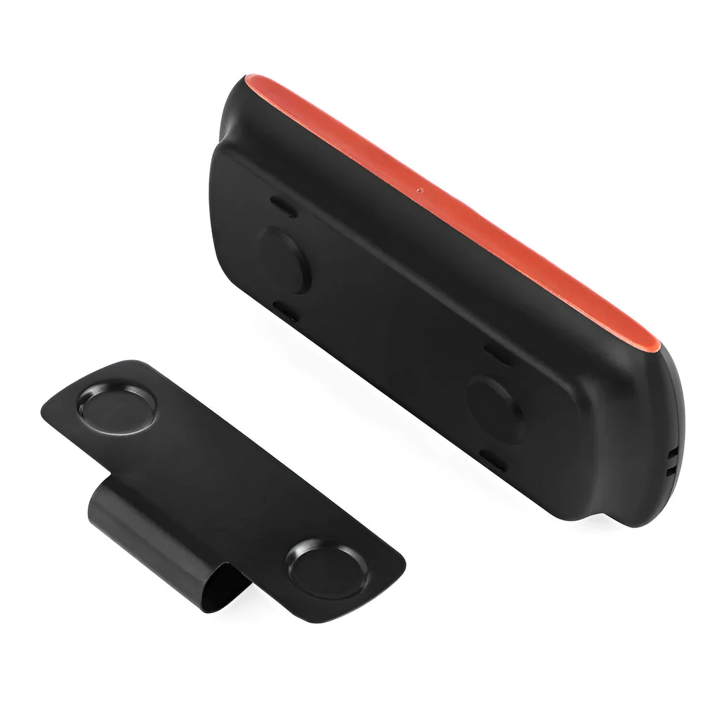 Orange plastic Bluetooth hands-free car kit mounted on a sun visor