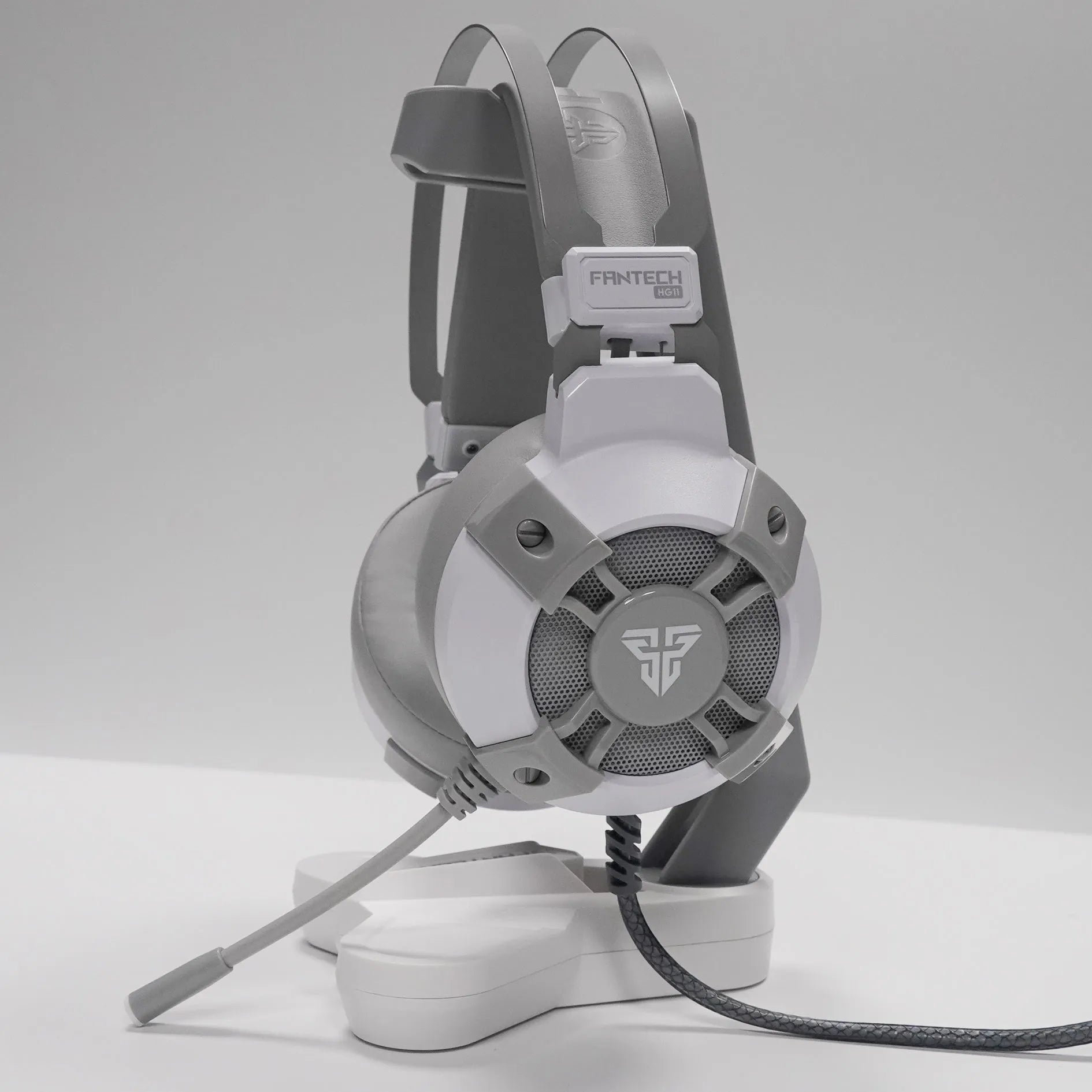 Black FANTECH HG11 gaming headset with RGB lights on earcups and a USB cable with inline remote