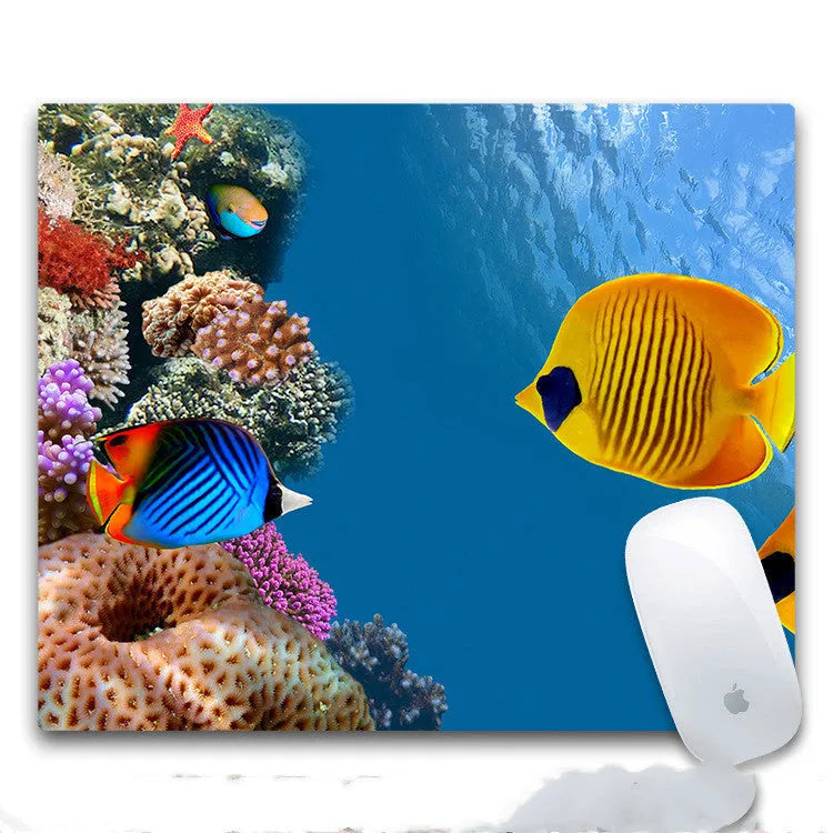 Custom printed rubber mouse pad on a desk, showing cloth surface and non-slip rubber base.