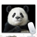 Custom printed rubber mouse pad on a desk, showing cloth surface and non-slip rubber base.