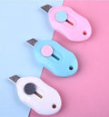 Cartoon-styled art knife with plastic and metal construction for manual production tasks
