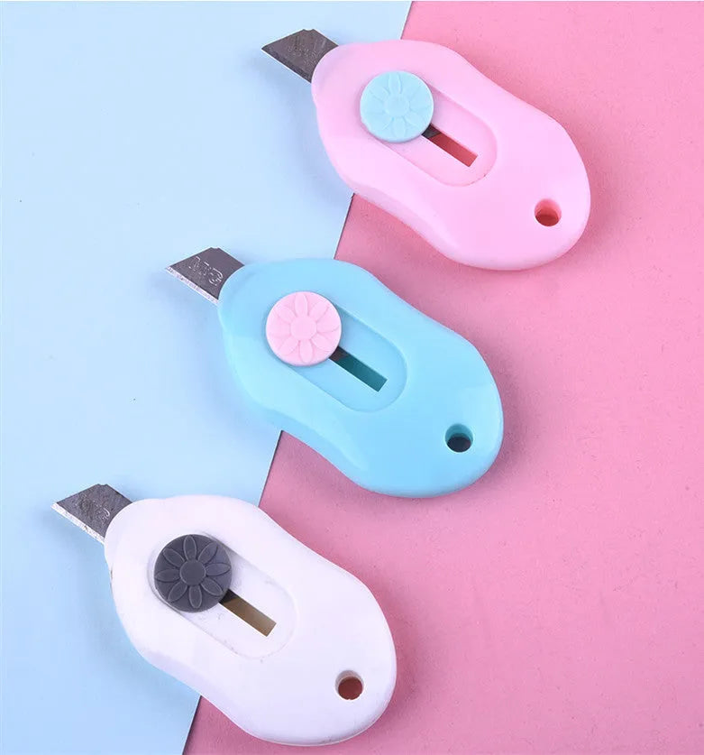 Cartoon-styled art knife with plastic and metal construction for manual production tasks