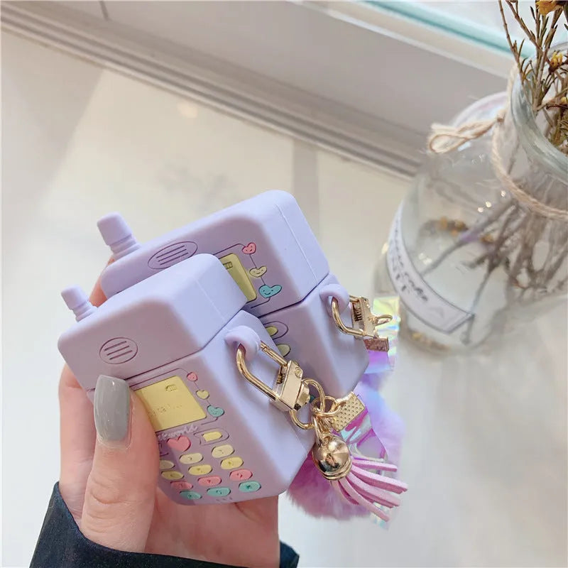 Purple silicone protective case for Apple AirPods wireless headphones with attached fur ball pendant accessory