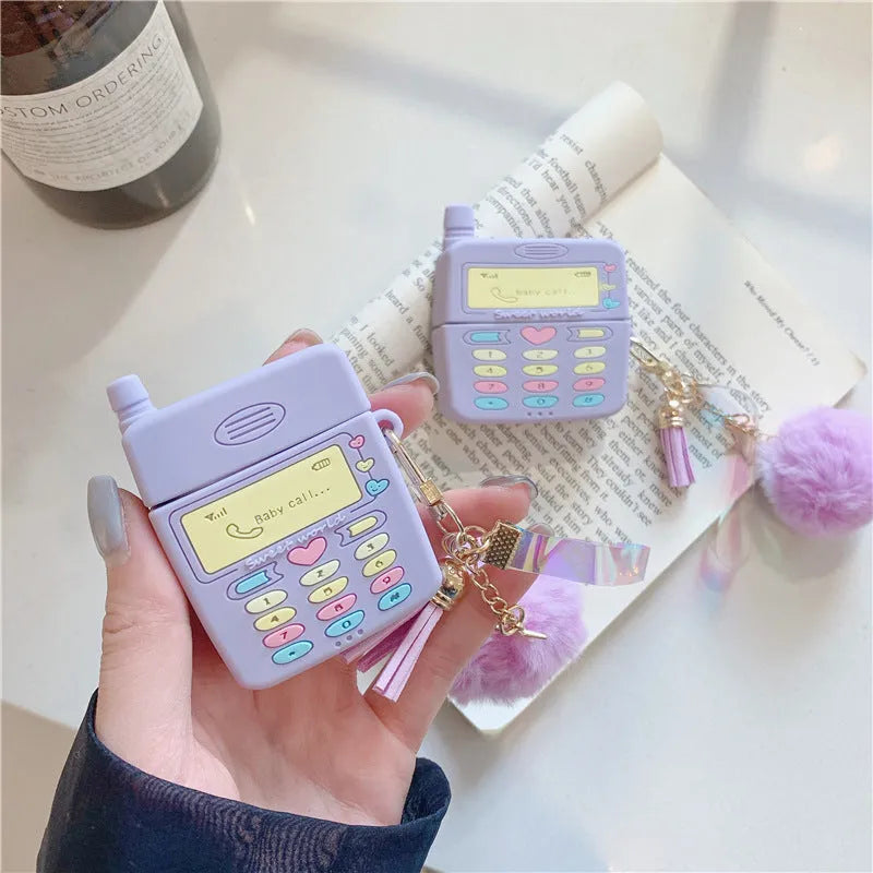 Purple silicone protective case for Apple AirPods wireless headphones with attached fur ball pendant accessory