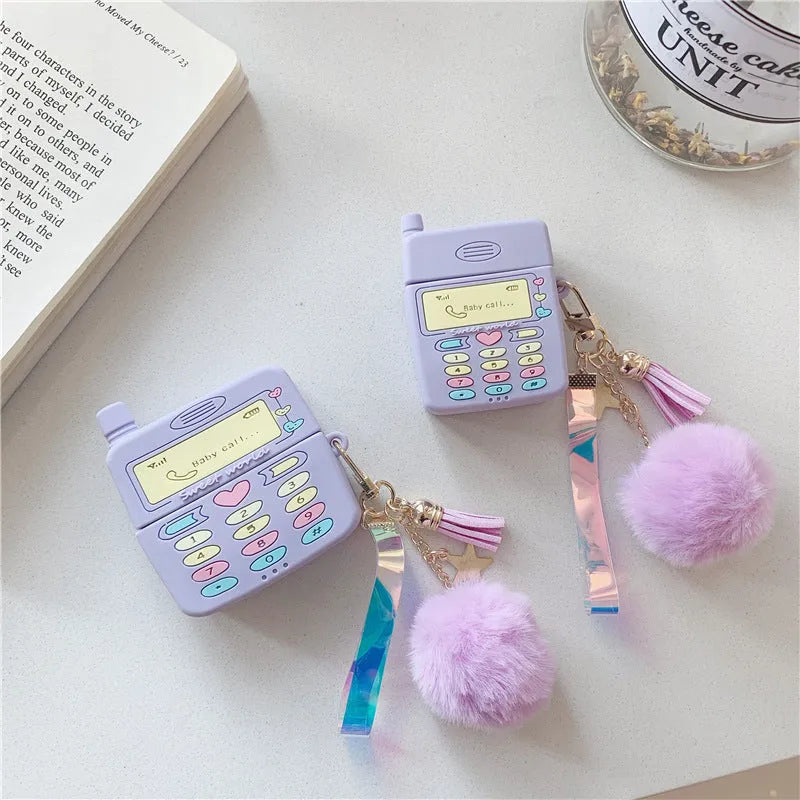 Purple silicone protective case for Apple AirPods wireless headphones with attached fur ball pendant accessory