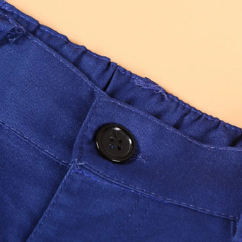 Blue boys' casual suit comprising a turtleneck, waistcoat, tie, and trousers on a hanger.
