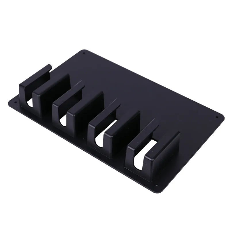 Black plastic clipper display box storage frame mounted on wall holding four electric hairdressing clippers