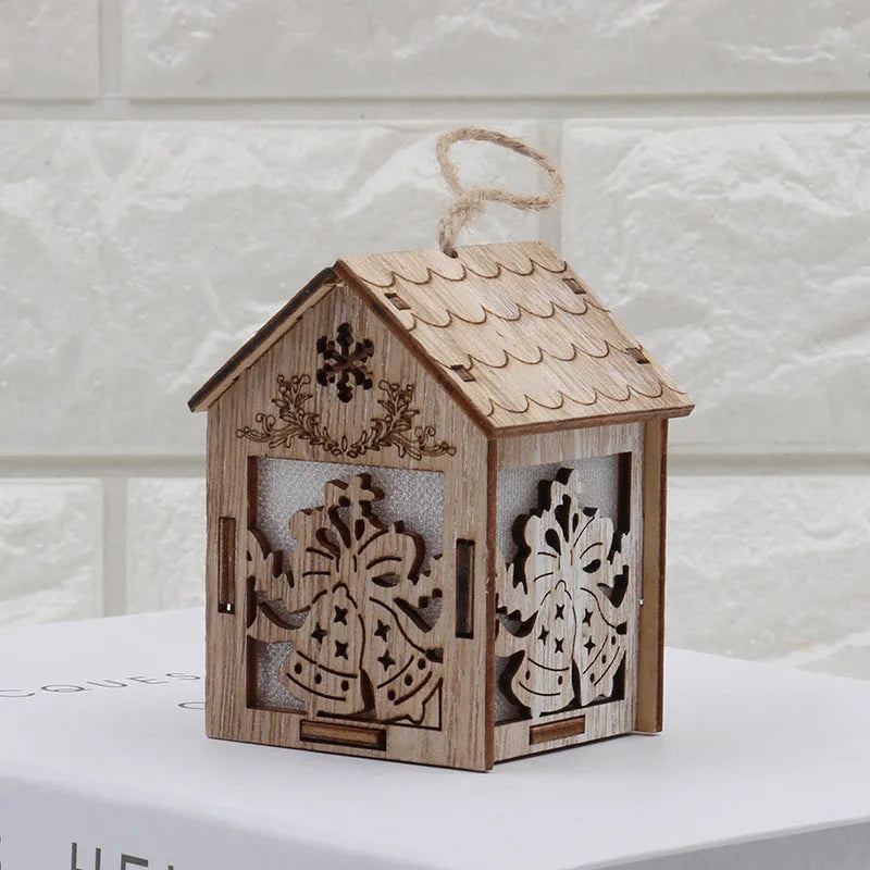 Set of three rustic handmade wooden Christmas ornaments: a small log bell, a Santa house, and a snowman house.