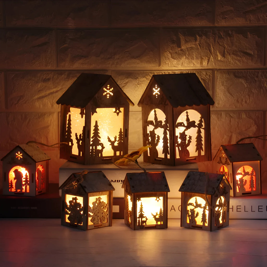 Set of three rustic handmade wooden Christmas ornaments: a small log bell, a Santa house, and a snowman house.
