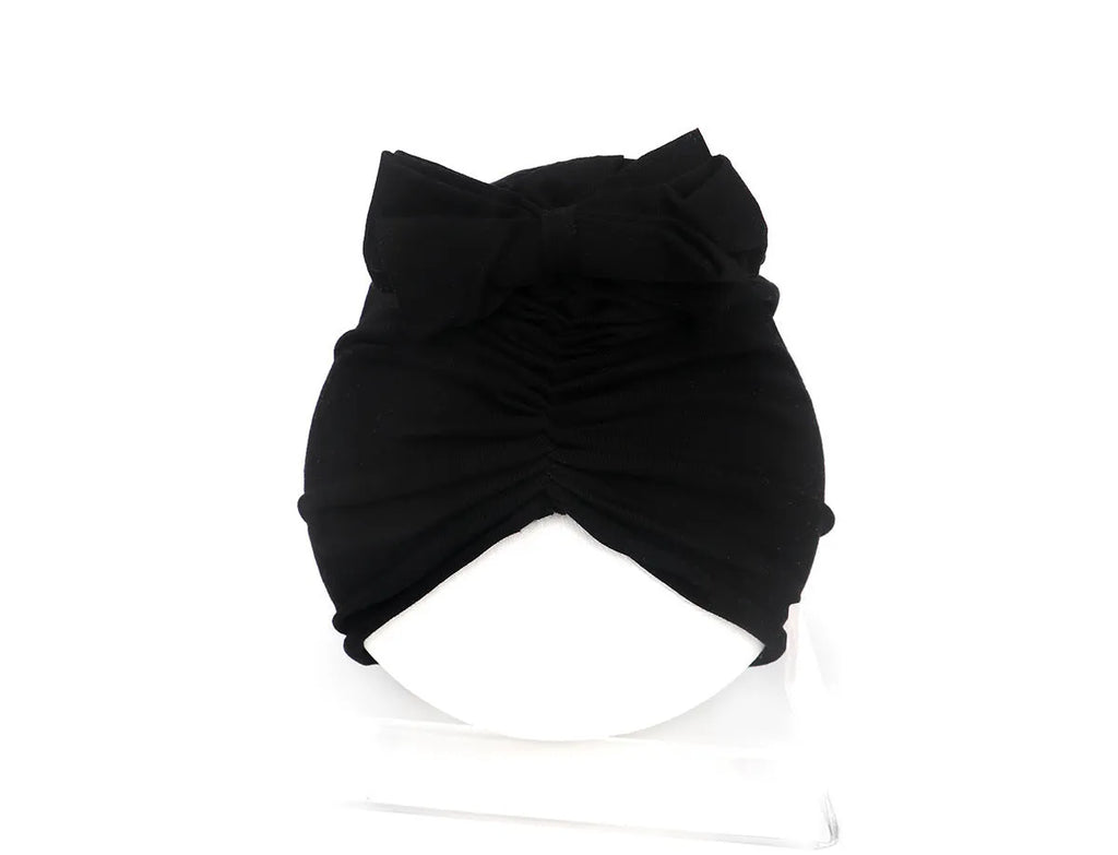 Soft acrylic knitted baby hat turban for infants and toddlers aged 0 to 28 months in a solid colour.