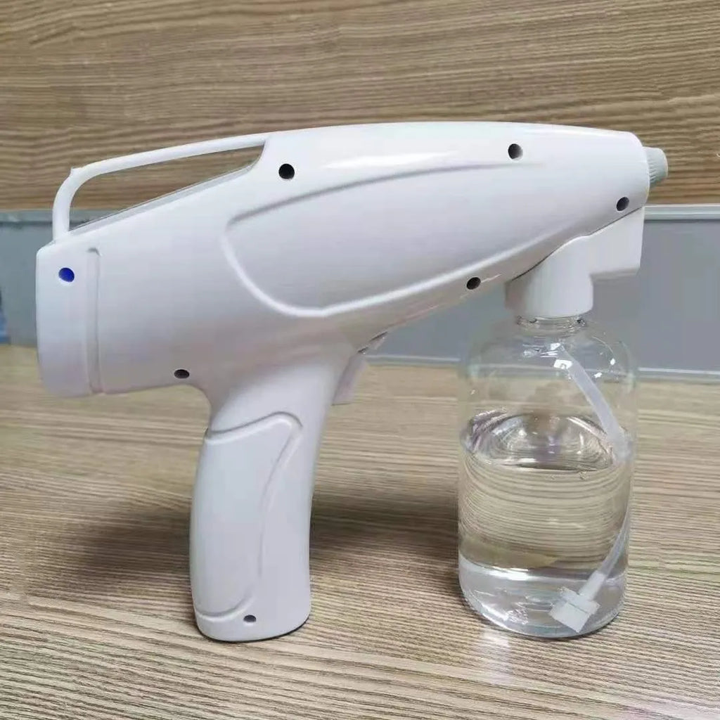 White handheld wireless electric spray disinfection gun with bottle and USB cable