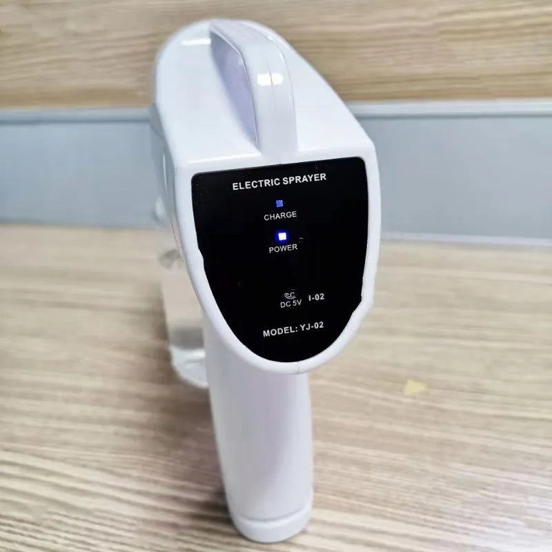 White handheld wireless electric spray disinfection gun with bottle and USB cable