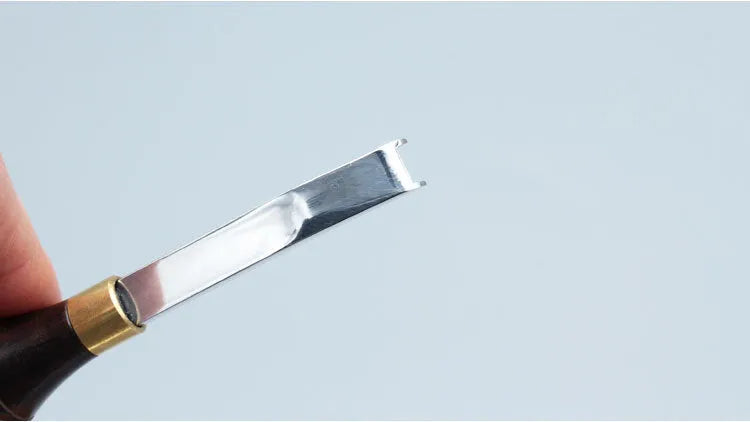 Leathercraft drum shovel edge shaver thinning knife with leather handle for wide edge sections.