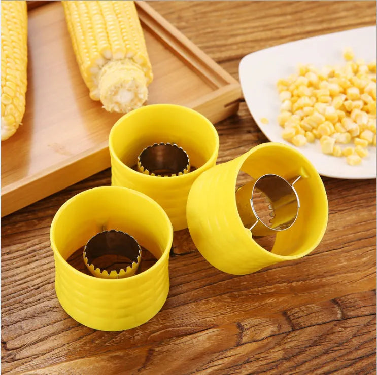 Yellow manual corn grinder thresher with corn-shaped design and stainless steel gear.