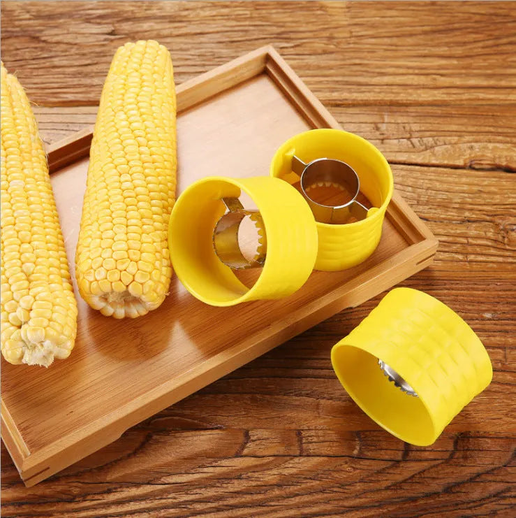 Yellow manual corn grinder thresher with corn-shaped design and stainless steel gear.