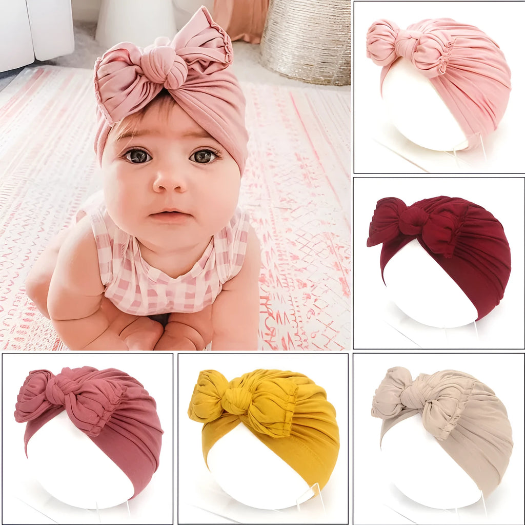 Soft acrylic knitted baby hat turban for infants and toddlers aged 0 to 28 months in a solid colour.