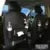 PU leather car seat back hanging storage bag with multiple pockets and built-in trash can.