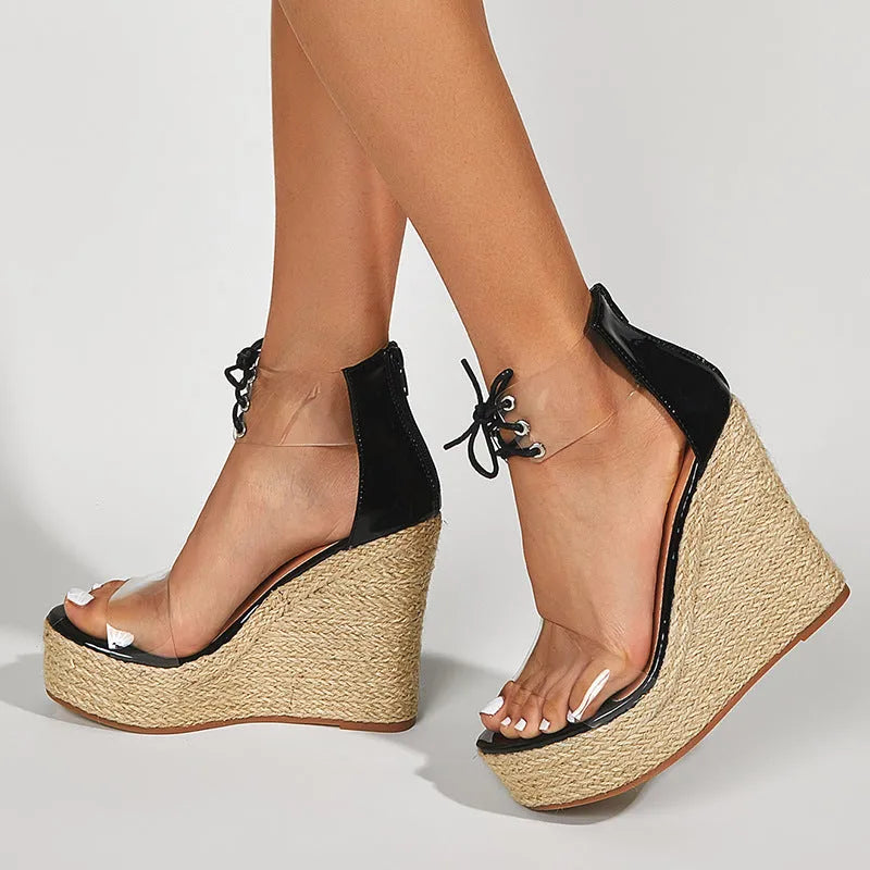 Black women's wedge sandals with hemp rope detail on a high platform heel and a front tie strap.