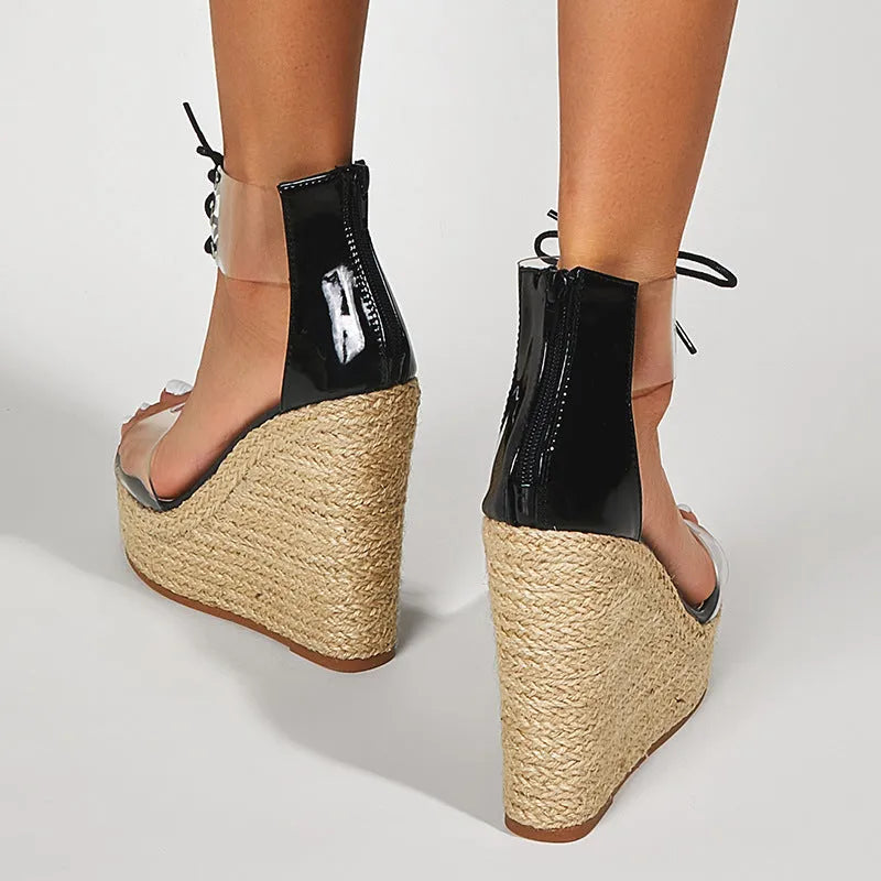 Black women's wedge sandals with hemp rope detail on a high platform heel and a front tie strap.