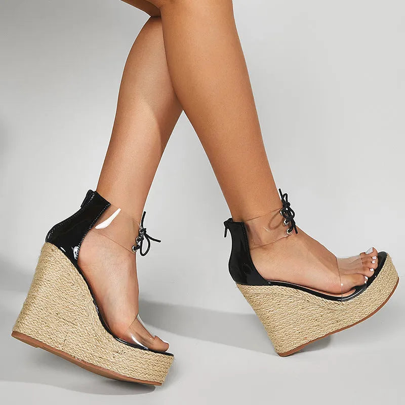 Black women's wedge sandals with hemp rope detail on a high platform heel and a front tie strap.