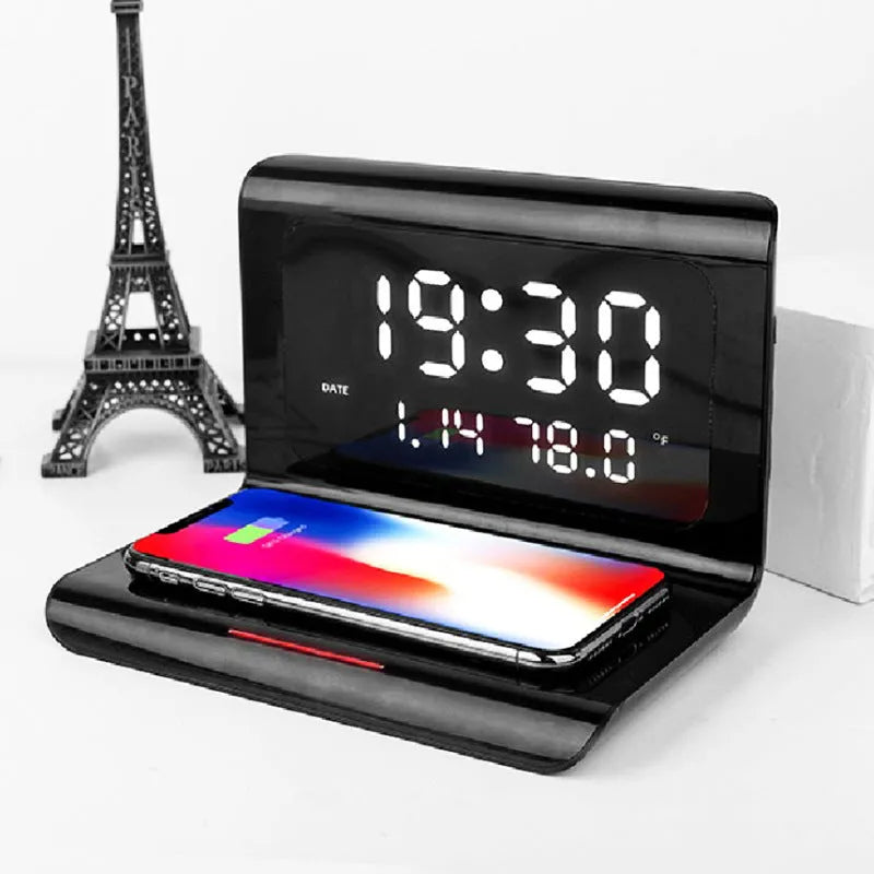 White wireless charger alarm clock showing time, calendar, temperature and humidity displays with charging surface