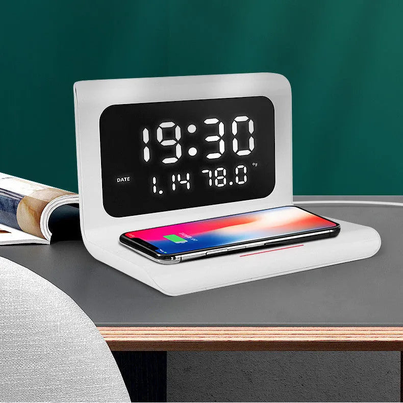 White wireless charger alarm clock showing time, calendar, temperature and humidity displays with charging surface