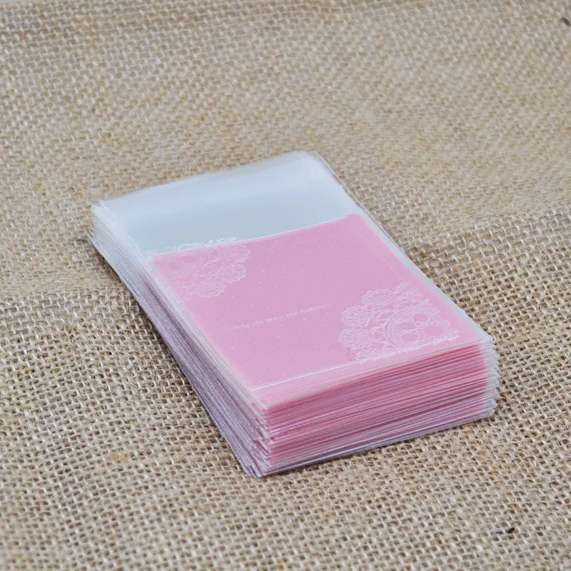 Pink self-adhesive plastic packaging bags, 7cm by 7cm with gusset, pack of 100.