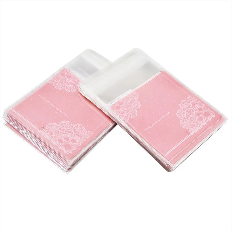 Pink self-adhesive plastic packaging bags, 7cm by 7cm with gusset, pack of 100.