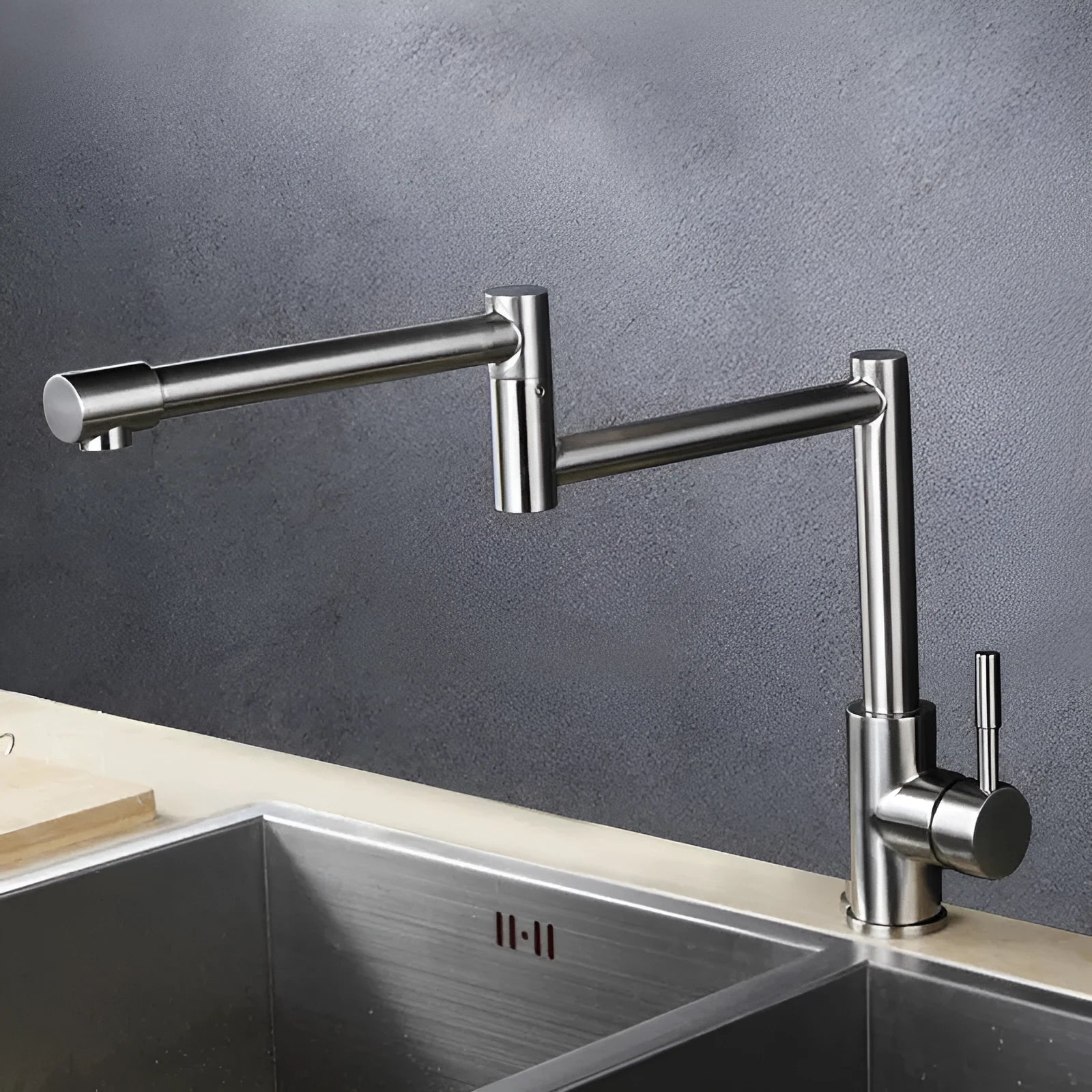 Silver stainless steel kitchen faucet with dual handles and rotating spout