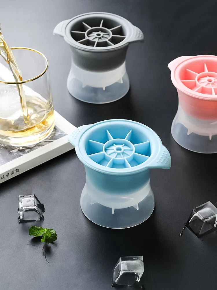 Silicone ice tray showing large mould cavities for ice hockey, spherical, round, and pentagonal shaped ice cubes.
