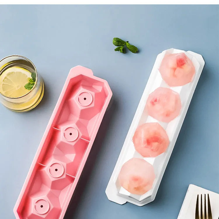 Silicone ice tray showing large mould cavities for ice hockey, spherical, round, and pentagonal shaped ice cubes.