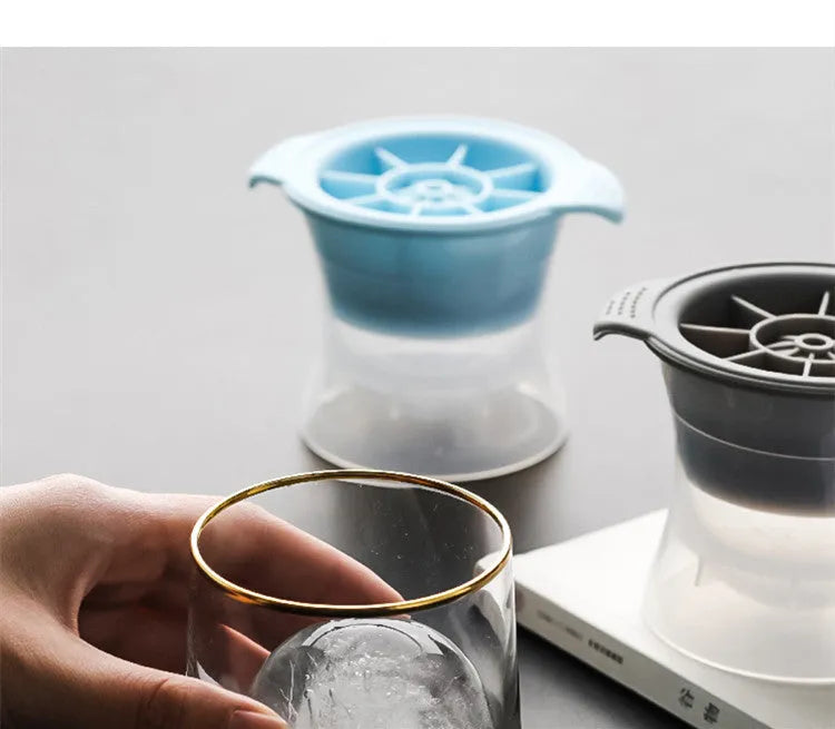 Silicone ice tray showing large mould cavities for ice hockey, spherical, round, and pentagonal shaped ice cubes.