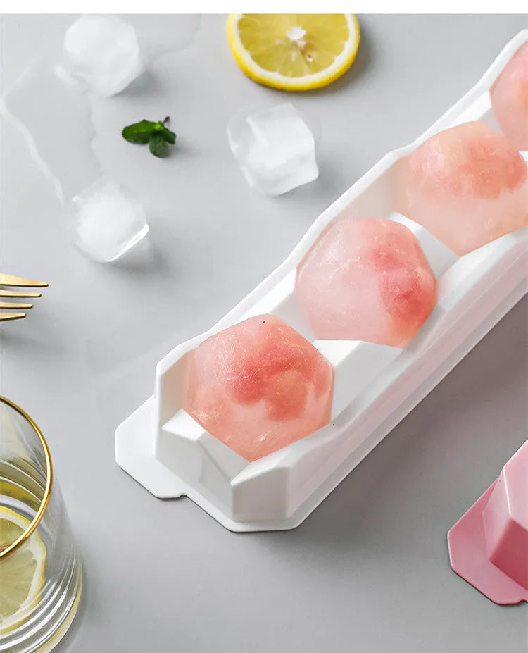 Silicone ice tray showing large mould cavities for ice hockey, spherical, round, and pentagonal shaped ice cubes.