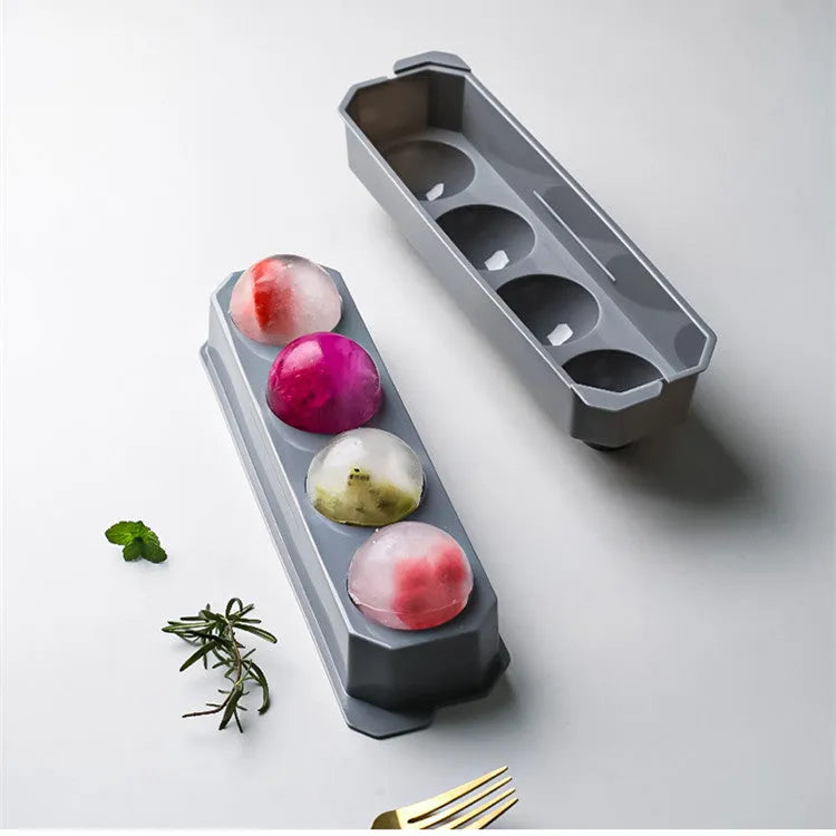 Silicone ice tray showing large mould cavities for ice hockey, spherical, round, and pentagonal shaped ice cubes.