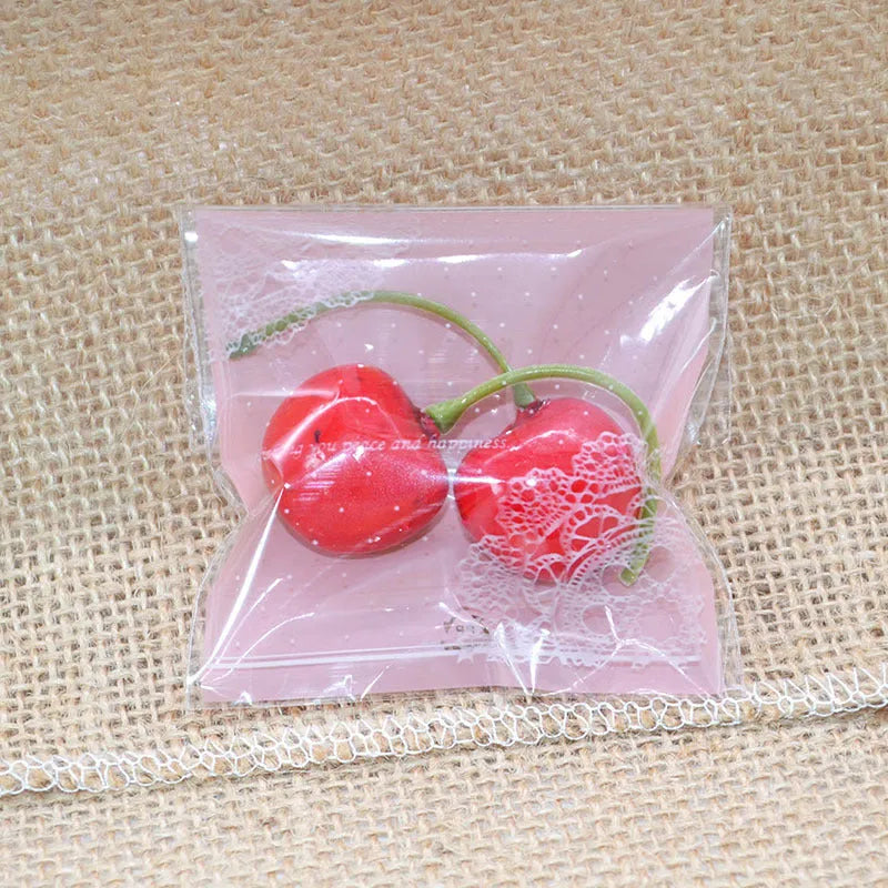 Pink self-adhesive plastic packaging bags, 7cm by 7cm with gusset, pack of 100.