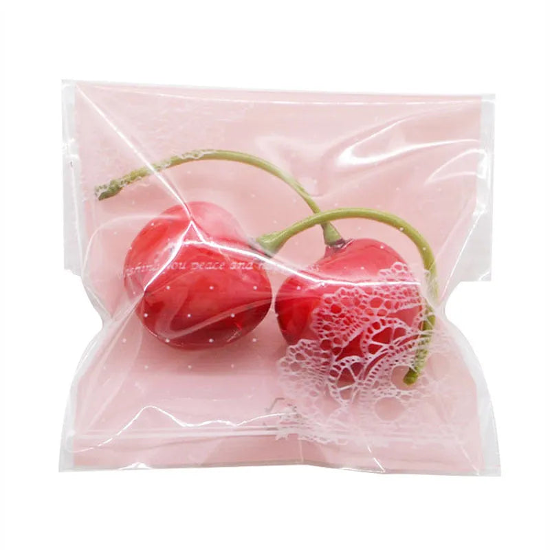 Pink self-adhesive plastic packaging bags, 7cm by 7cm with gusset, pack of 100.