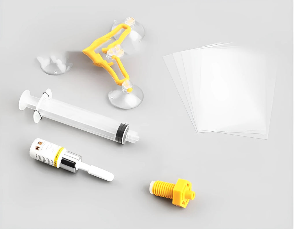 Yellow auto glass repair tool with triangle bracket and 2ML repair fluid on a car windshield