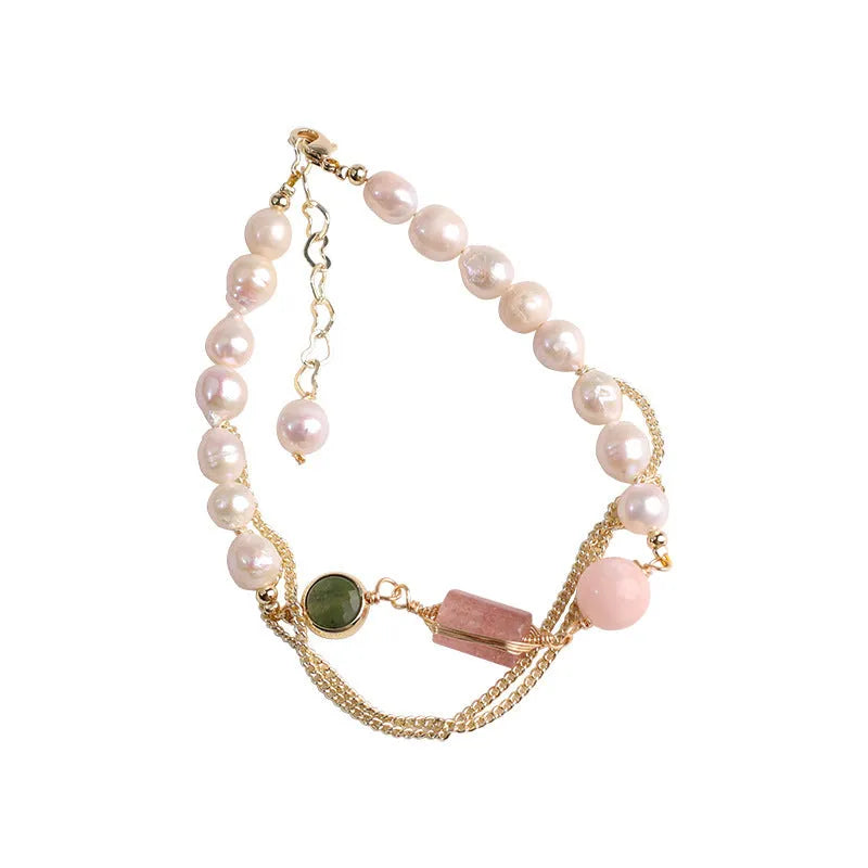 Women's pink freshwater pearl bracelet with geometric strawberry crystal charms on wrist