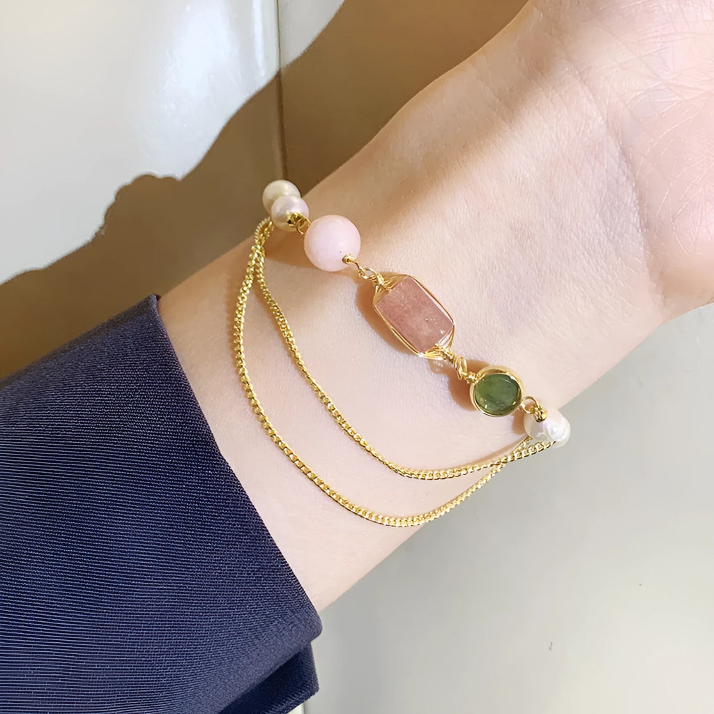 Women's pink freshwater pearl bracelet with geometric strawberry crystal charms on wrist