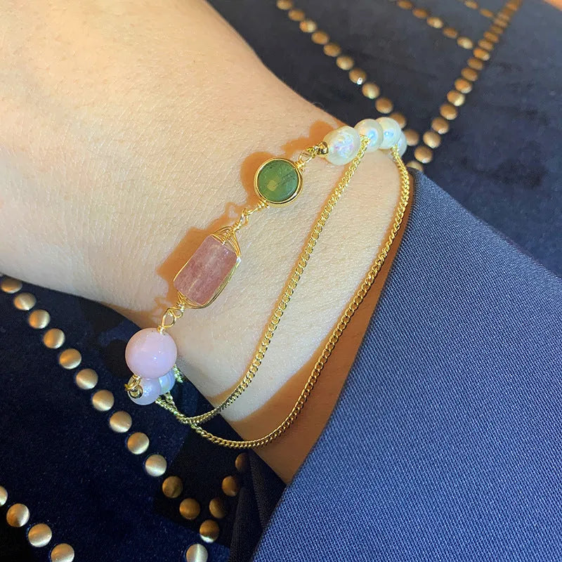 Women's pink freshwater pearl bracelet with geometric strawberry crystal charms on wrist